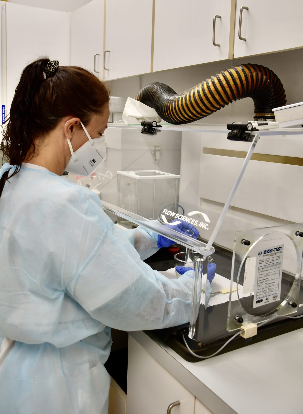 Pharmacist compounding medication in the lab fume hood at Ryan's Pharmacy
